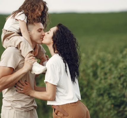 A heartwarming family moment captured in a field, highlighting love and togetherness.